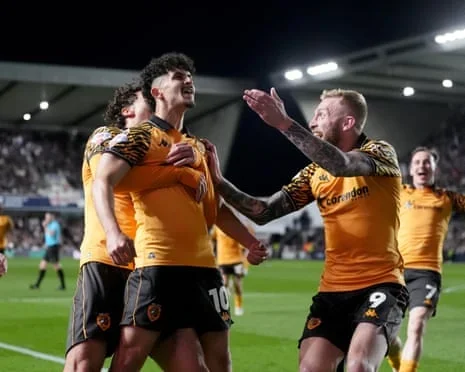 Hull players rush to Mohamed Belloumi after the substitute opens the scoring against Millwall.
