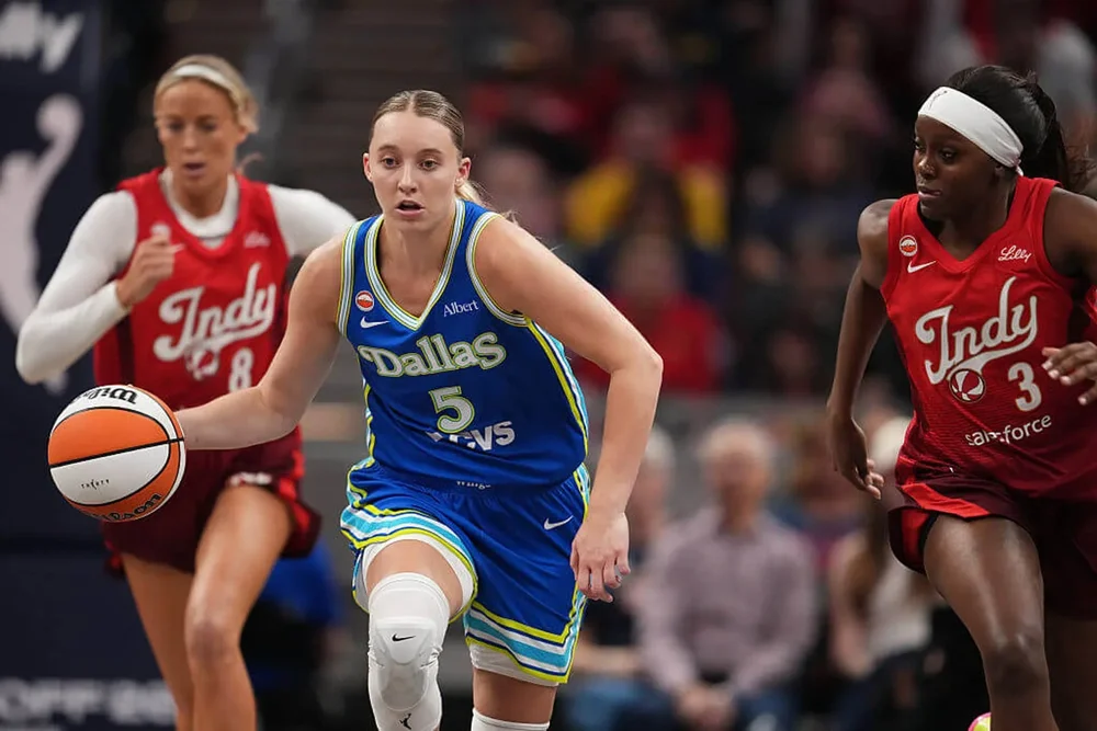 Paige Bueckers drives to the basket ahead of Fever defenders during the Wings' season-opener victory in Indianapolis.